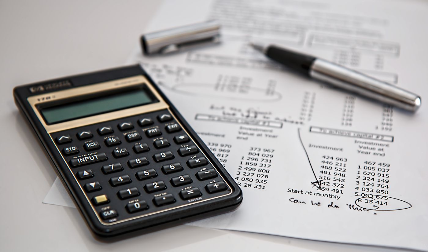 Financial documents and calculator representing tariff margin analysis quality controls